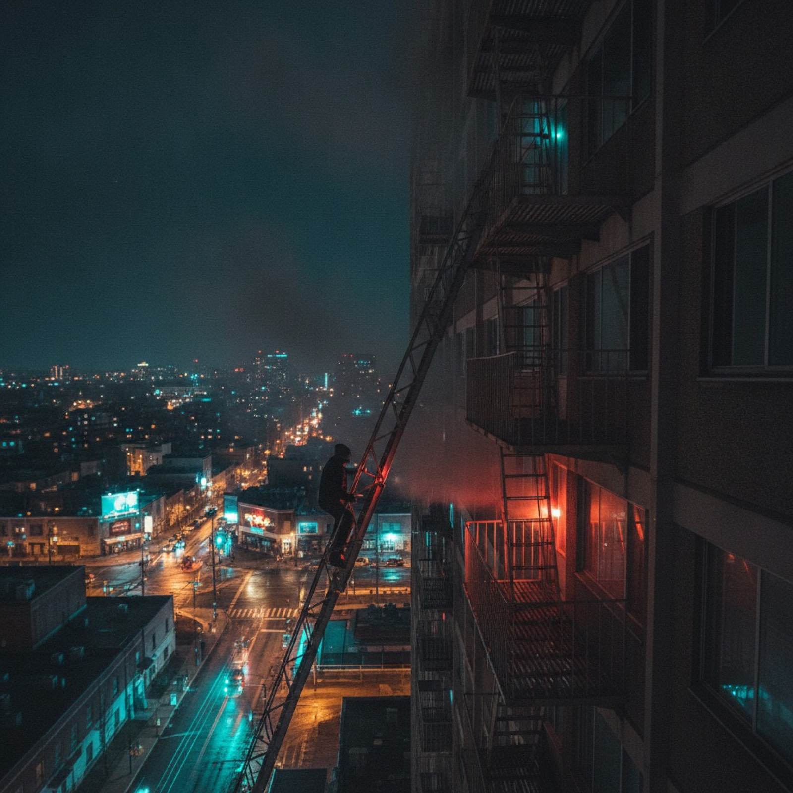 Portable fire escape ladder hooked over an apartment windowsill